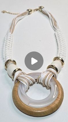 a white necklace with wood and glass beads