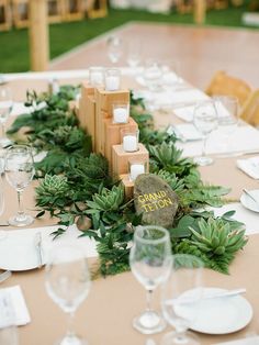 the table is set with white plates and place settings