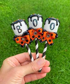 three halloween candy lollipops in the shape of numbers on top of each other