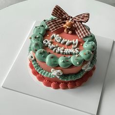 a birthday cake decorated with green and red icing that says merry christmas on it