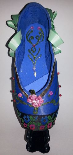 a blue shoe with floral decorations on it