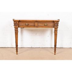 an old wooden table with two drawers on one side and a drawer on the other