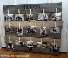 family pictures are hung on wooden planks with clothes pins attached to the pegs