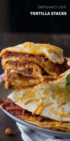 three tortilla stacks stacked on top of each other with cheese and tomato sauce