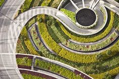 an aerial view of a circular garden with trees and plants on the side of it