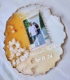 a couple's photo on a glass plate with flowers in the middle and text that reads, together forever