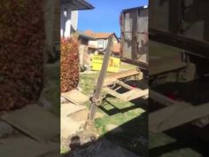 an old truck is parked in front of a house with a sign on it's side