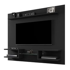 a flat screen tv mounted to the side of a wall with shelves and lights on it