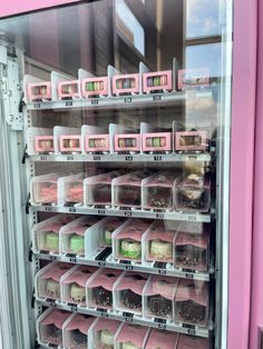 a pink vending machine filled with lots of different types of cakes and cupcakes