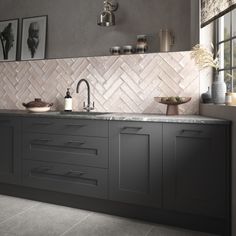 a kitchen with gray cabinets and white tile backsplash