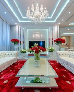 a living room filled with white couches and red carpet