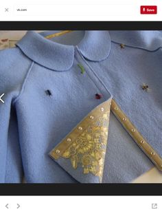 an image of a blue shirt with gold buttons on the collar and side, showing how to sew