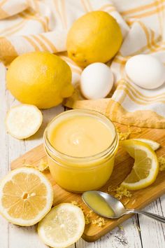 a wooden cutting board topped with sliced lemons and a jar of mayonnaise