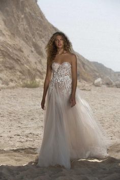 a woman in a wedding dress on the beach