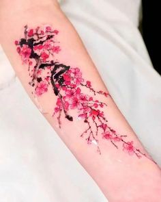 the arm is decorated with pink flowers and branches