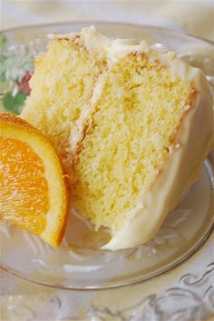 a piece of cake and an orange slice on a plate