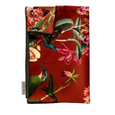 a red floral print pocket wallet with hummingbirds on it