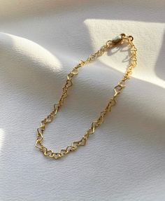 Delicate 14kt gold filled heart chain bracelet. The delicate and minimalist design of this link bracelet goes well with both casual and sophisticated looks. Wear it on its own or layered with other bracelets in our shop. Perfect for a gift! ✦ MATERIALS ✦ 14kt gold filled heart chain and lobster claw clasp. ✦ SIZING ✦ Available in 3mm width. ✦ PACKAGING ✦ All orders are packed in jewelry boxes/pouches with a brand logo, which makes it perfect for gifting. All packaging materials including mailers Heart Link Bracelet, Delicate Heart Bracelet With Delicate Chain, Delicate Heart-shaped Bracelets With Adjustable Chain, Minimalist Adjustable Chain Bracelet For Valentine's Day, Trendy Gold Heart Bracelet With Chain, Dainty Chain Bracelet For Valentine's Day, Dainty Heart Bracelet With Delicate Chain For Valentine's Day, Dainty Gold Bracelet With Heart Charm, Dainty Gold Plated Heart Bracelet