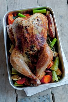 a roasting pan filled with chicken and vegetables