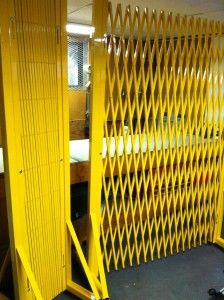 a room divider that is yellow with metal bars on the top and bottom sides