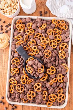 a tray full of dog food with pretzels and chocolate chips on the side