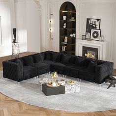 a living room filled with furniture and a fire place next to a white rug on top of a hard wood floor