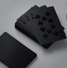 four playing cards are sitting on top of each other