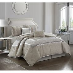 the comforter set is made up in beige and silver colors, with white trimmings