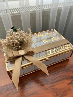 a bouquet of flowers sitting on top of a wooden table next to a glass box