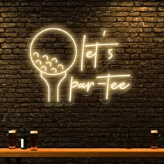 a neon sign that reads, let's pour - fee on the side of a brick wall