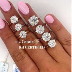 a woman's hand with five different rings on it and the words carats igi certified