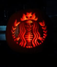 a starbucks pumpkin carved to look like a skeleton