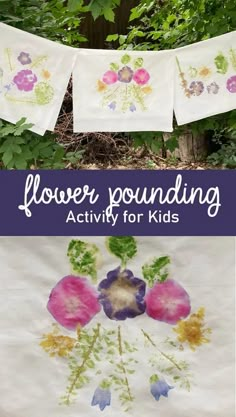 flowers are painted on white paper with purple and green leaves hanging from the clothes line