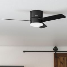 a black ceiling fan in a white room