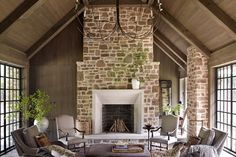 a living room filled with furniture and a fire place in the middle of a room