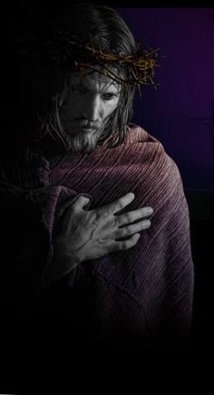 jesus carrying the cross in his arms with purple light shining on him and dark background