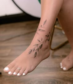 a close up of a person's foot with a tattoo on it