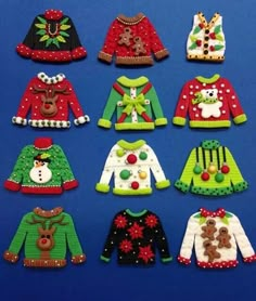 knitted christmas sweaters are displayed on a blue surface