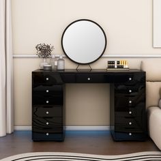 a black desk with drawers and a round mirror on the top shelf next to it