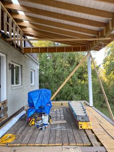 the back deck is covered with blue tarp and some tools are sitting on it