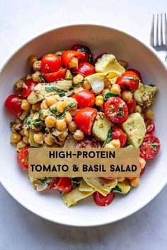 high protein tomato and basil salad in a white bowl with a fork on the side