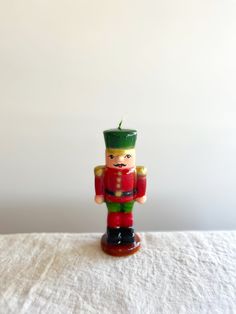 a nutcracker figurine on a white table cloth