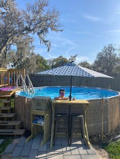 a man sitting in an above ground swimming pool