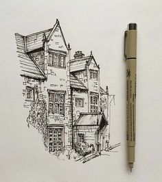 a drawing of a house with a pen in front of it and the image is drawn on paper