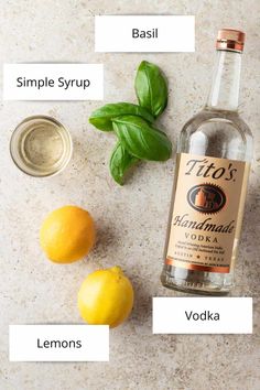 ingredients to make an alcoholic cocktail including lemons and basil