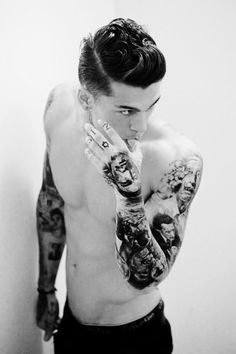 a shirtless man with tattoos on his arms and chest is posing for the camera