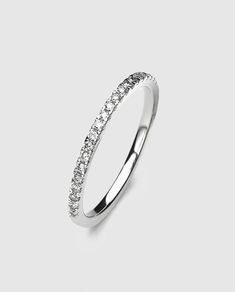 a white gold wedding ring with diamonds on the sides and a thin band in the middle