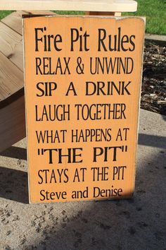 a wooden sign that says fire pit rules relax & unwind sip a drink laugh together