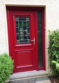 a red front door with glass panes