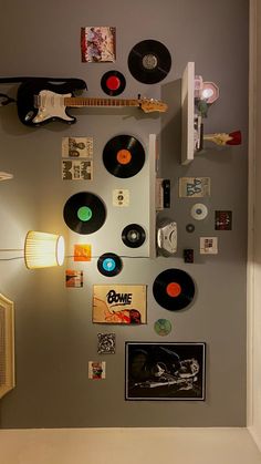 there are many records on the wall and some lights in the room with them attached to the wall